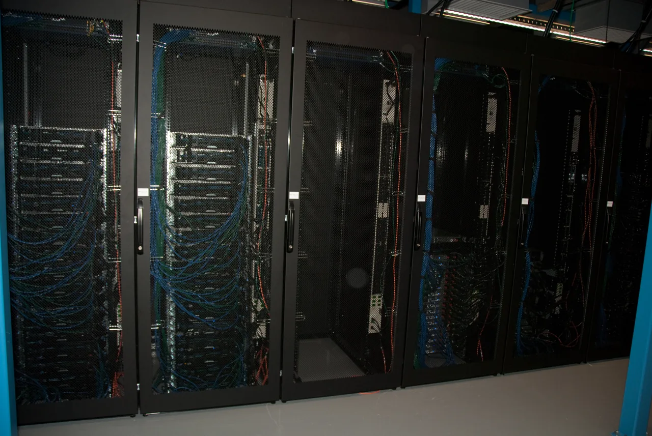 Rows of server racks and network cabling at Wikimedia’s eqiad datacenter.