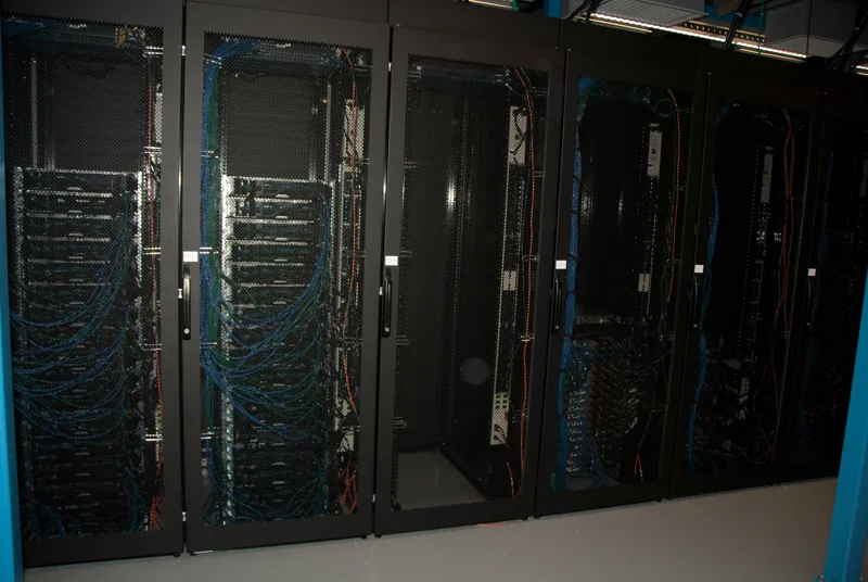 Rows of server racks and network cabling at Wikimedia’s eqiad datacenter.